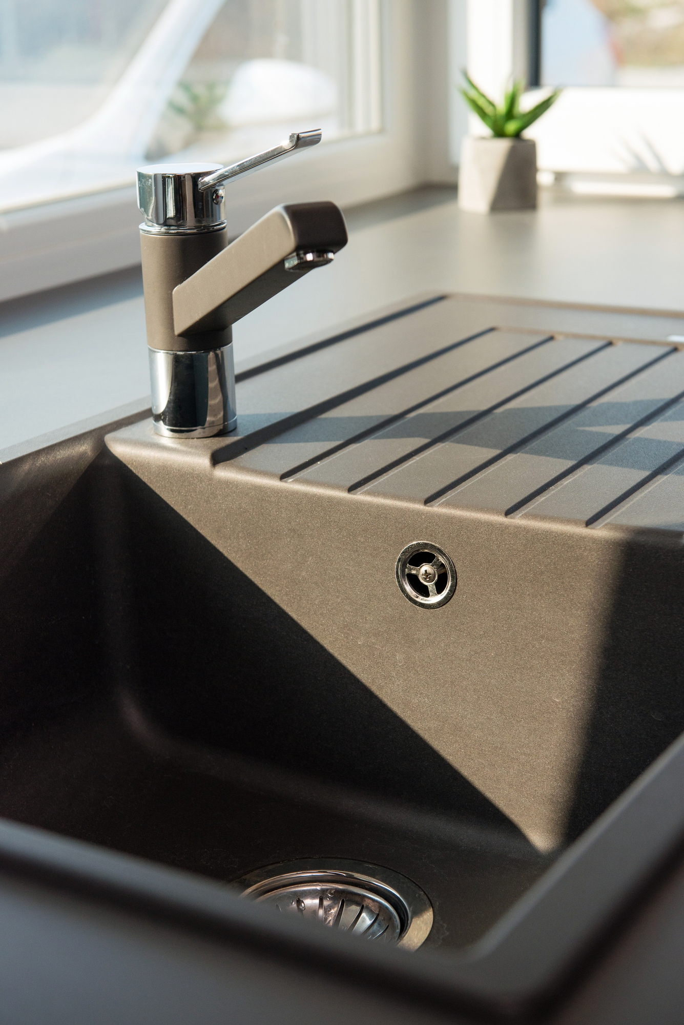 Detail of faucet and sink in contemporary kitchen